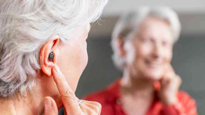 Mulher a fazer um teste auditivo junto de uma audiologista