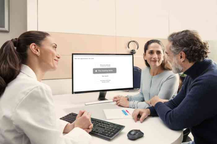 Audiologista Minisom explica resultados do audiograma ao casal.