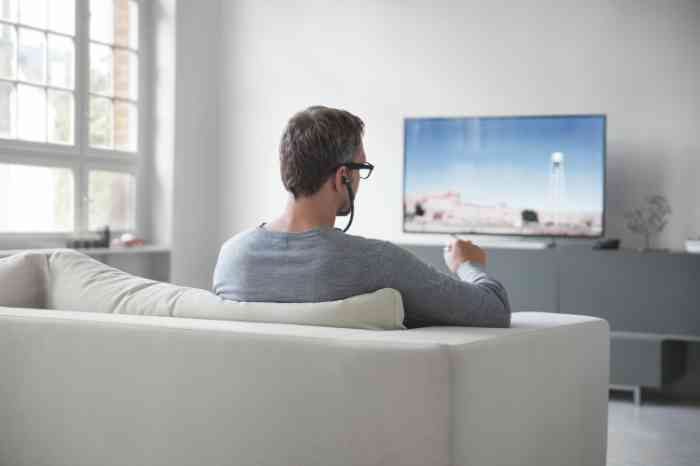 Senhor com auricular para ouvir a TV